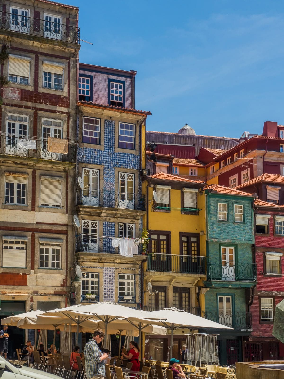 Tiled and painted facades stacked along the Porto riverfront